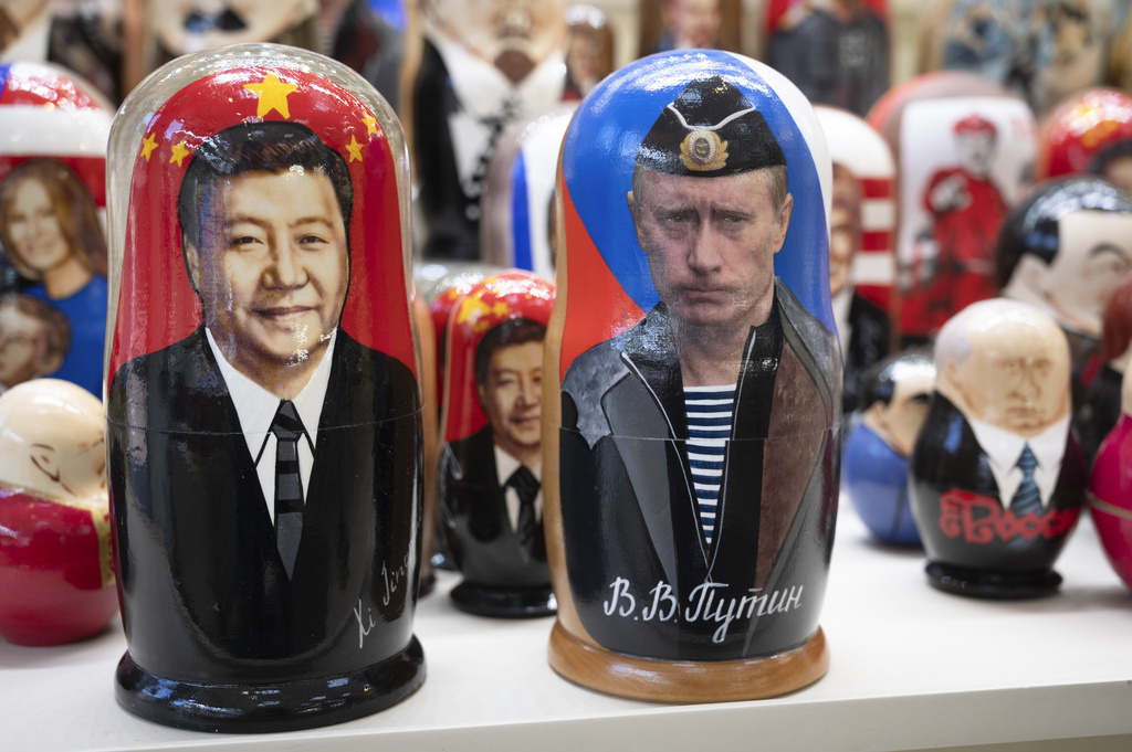 Russian matryoshka dolls with portraits of Chinese President Xi Jinping, left, and Russian President Vladimir Putin are displayed among others for sale at a souvenir shop in Moscow, Russia, Tuesday, March 21, 2023. Chinese President Xi Jinping arrived in neighbouring Russia for a three-day trip for the talks with Russian President Vladimir Putin. Source: AP Photo/Dmitry Serebryakov