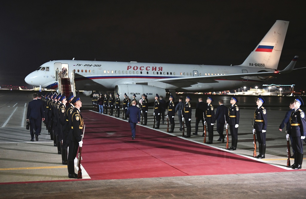 Russian President Putin, center back to a camera, arrives to meet released Russian prisoners at the Vnukovo government airport outside Moscow, Russia, on Thursday, Aug. 1, 2024. The United States and Russia have made their biggest prisoner swap in post-Soviet history. Sergei Ilyin, Sputnik, Kremlin Pool Photo via AP.