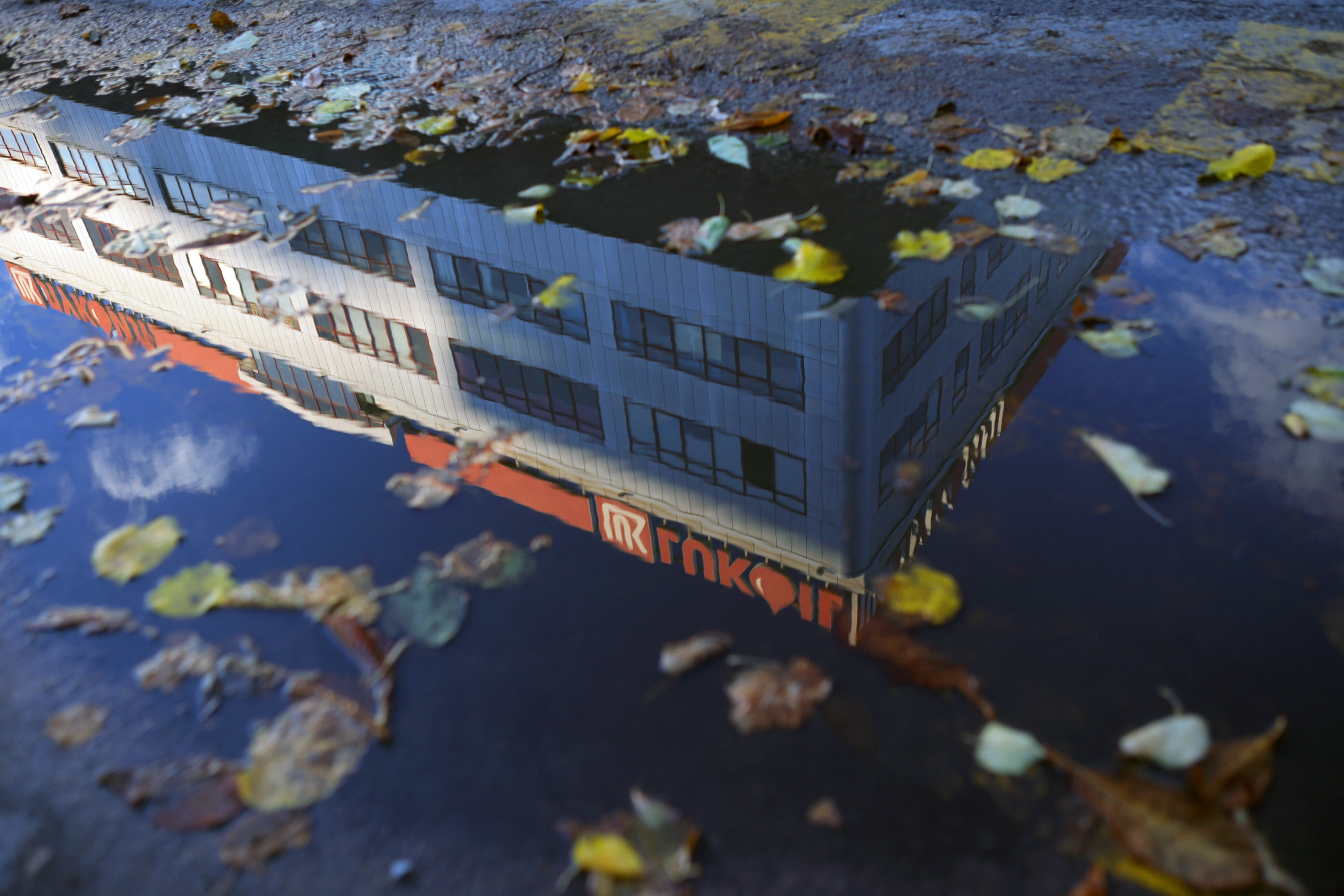 The building of Lukoil headquarters is refelcted in a puddle in Sofia, Bulgaria, Tuesday, Oct. 28, 2025. Source: AP Photo.