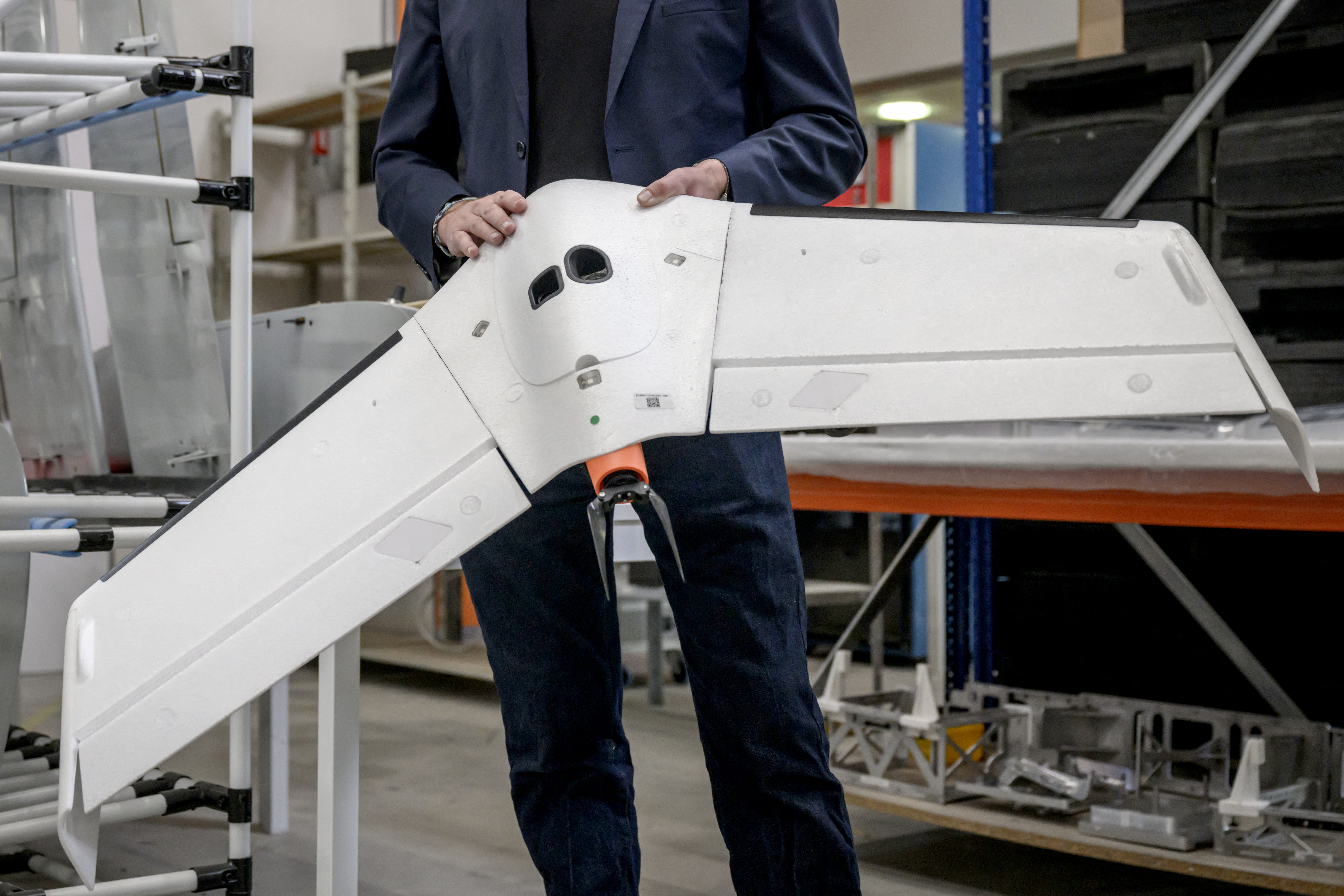 Delair's co-founder Bastien Mancini holds an 'Oskar' drone, capable of carrying warheads for military use, at the company's factory in Labege, south-western France, on April 11, 2025. With recognised experience in the Ukrainian conflict, the Toulouse drone manufacturer Delair has taken off with a production focused on the defense industry, an upward trajectory in which the geopolitical context could play the role of tailwindsPhoto by Ed JONES. Source: gettyimages.