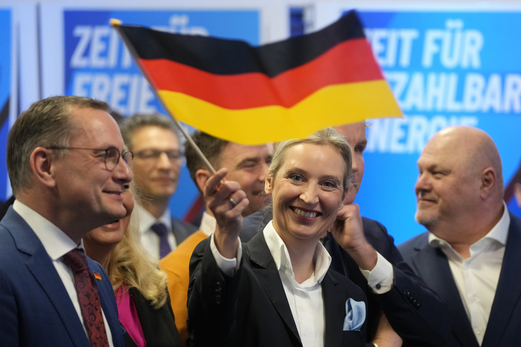 Leader of far right AfD Alice Weidel waves a German flag at the AfD party headquarters in Berlin  after the German national election. Source: AP Photo/Michael Probst