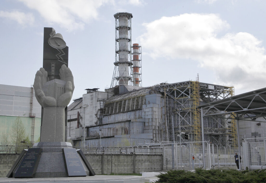 View of a closed reactor number 4 of Chernobyl nuclear power plant with the Chernobyl Monument in foreground, erected in 2006. Source: AP Photo/ Efrem Lukatsky