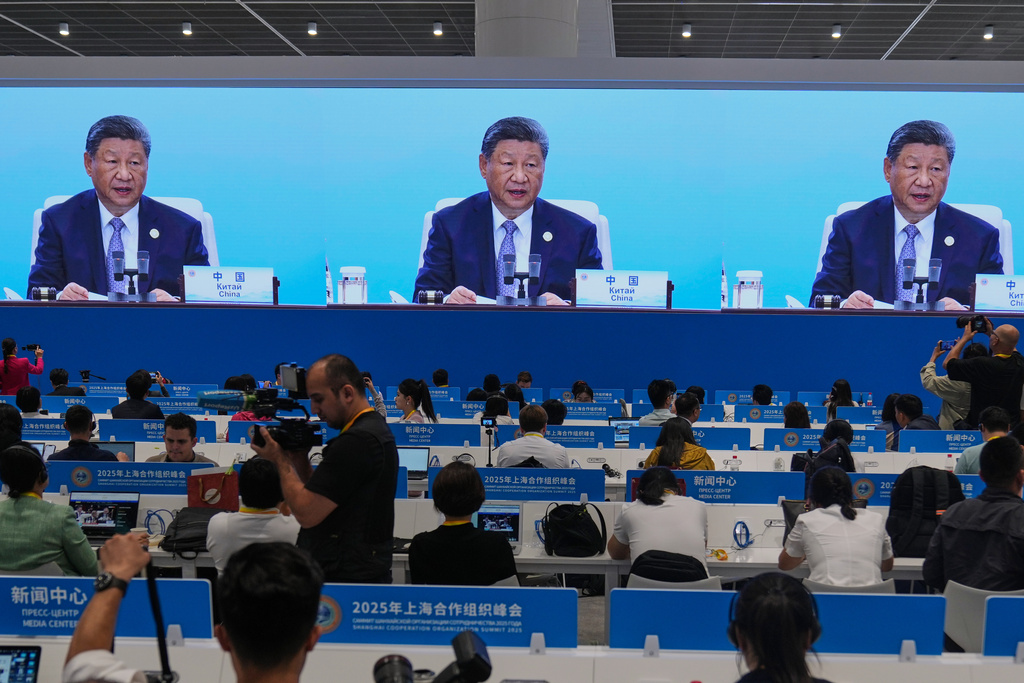 Journalists film a screen at the media center broadcasting live of Chinese President Xi Jinping, chairing the summit with leaders of member countries of the Shanghai Cooperation Organization in Tianjin, China , Monday, Sept. 1, 2025. Source: AP Photo.