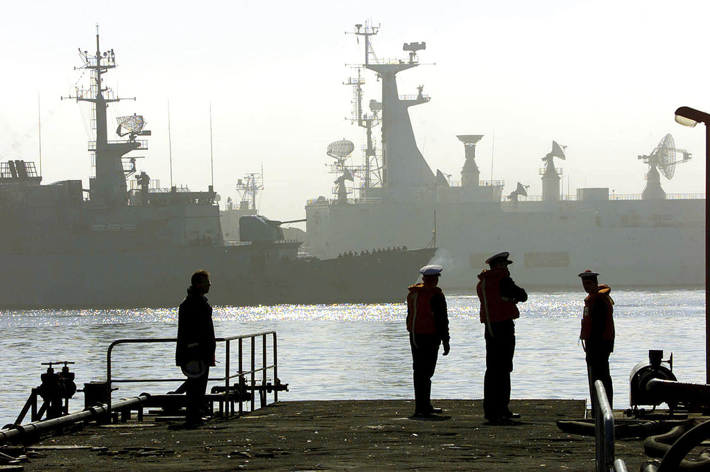 French sailors watch frigates of the nine-frigate fleet of NATO's Standing Naval Force Atlantic, as the ships dock alongside Brest's harbour, western France, Friday Sept. 21 2001. The fleet, the world's first permanent peacetime multinational naval squadron, under the Supreme Allied Commander Atlantic and headquartered in Norfolk, Va., is heading to the Mediterranean to take part in long-time scheduled maneuvers, and put into Brest for a three-day technical and supply stop, not linked to the recent attacks in the United States. Source: AP Photo.
