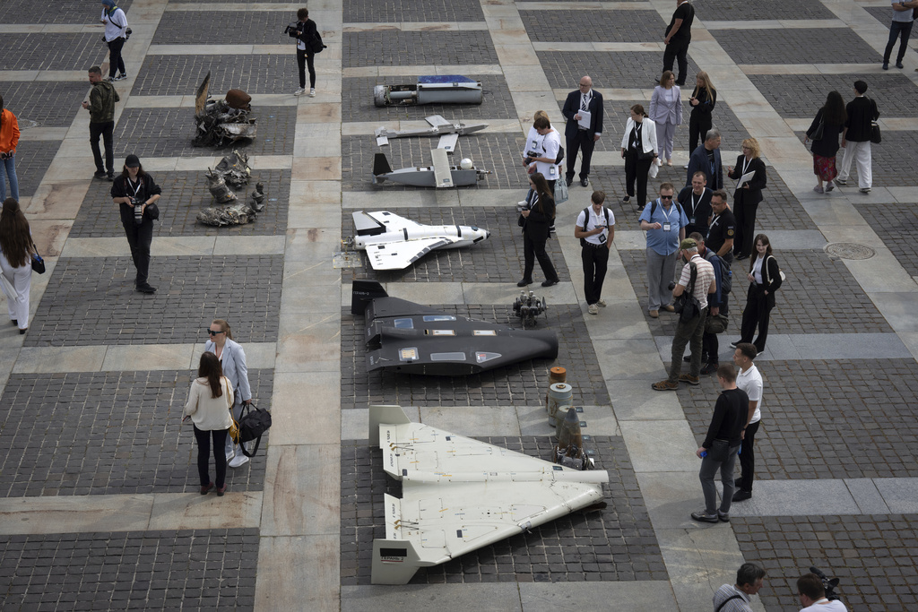 Visitors watch damaged Russian drones during the International Conference on Expanding Sanctions Against Russia in Kyiv, Ukraine, Friday, June 27, 2025. Source: AP Photo.